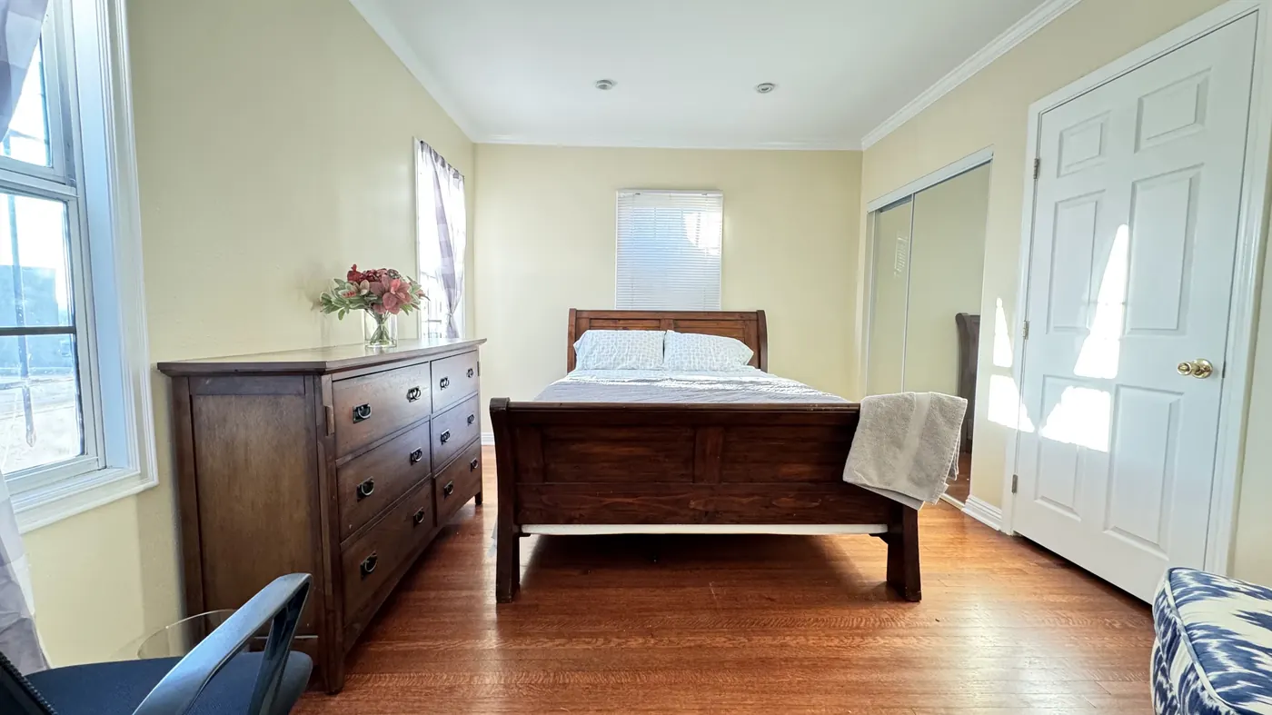 Master bedroom with dresser and bed